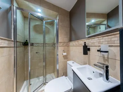 a bathroom with a shower and a toilet and a sink at 3 Bed in Portpatrick 77308 in Portpatrick