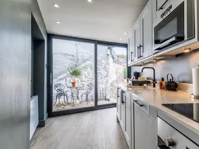 a kitchen with a large window and a table with chairs at 3 Bed in Portpatrick 77308 in Portpatrick