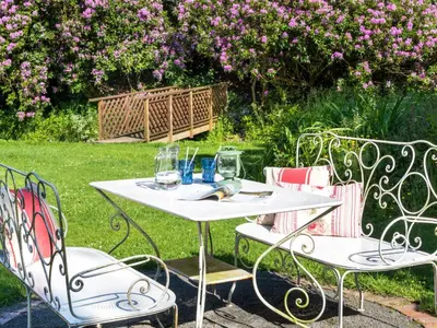 a white table and chairs with wine glasses on it at 6 Bed in Workington oc-sz151 in Lamplugh