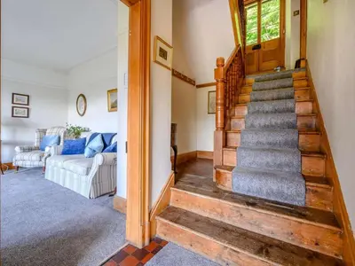 a living room with a staircase and a couch at 3 Bed in Eskdale SZ072 in Santon Bridge