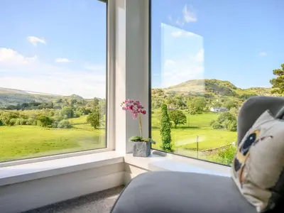 a room with a window with a chair and a view at 3 Bed in Eskdale SZ072 in Santon Bridge