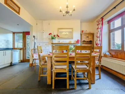 a kitchen with a dining room table and chairs at 3 Bed in Eskdale SZ072 in Santon Bridge