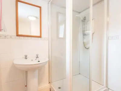 a white bathroom with a sink and a shower at 8 Bed in Applethwaite SZ373 in Applethwaite