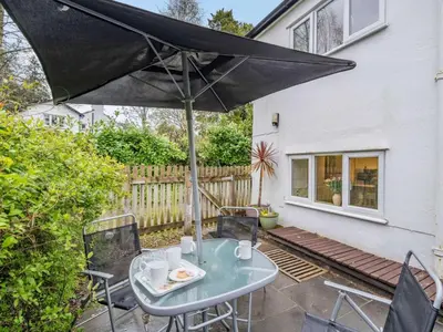 a patio with a table and an umbrella at 3 Bed in Keswick oc-sz446 in Portinscale