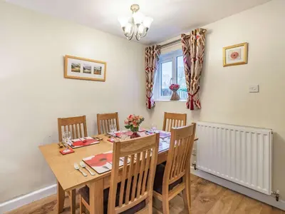 a dining room with a wooden table and chairs at 3 Bed in Keswick oc-sz446 in Portinscale