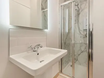 a white bathroom with a sink and a shower at 9 Bed in Keswick oc-sz238 in Keswick