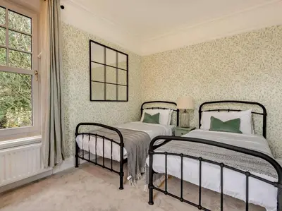 a bedroom with two beds and a window at 9 Bed in Keswick oc-sz238 in Keswick