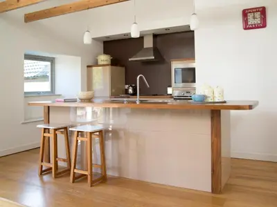 a kitchen with a counter with stools and a sink at 3 Bed in Egremont oc-sz230 in Hale