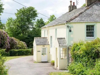 a small white house with a small shed at 6 Bed in Workington oc-sz327 in Lamplugh