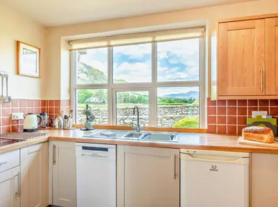 a kitchen with a sink and a window at 3 Bed in Keswick oc-sz148 in Grange