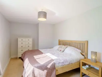 a bedroom with a bed and a dresser and a lamp at 3 Bed in Bassenthwaite 84024 in Bassenthwaite