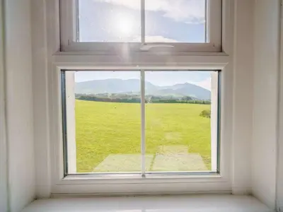 a window with a view of a green field at 3 Bed in Bassenthwaite 84024 in Bassenthwaite