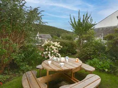 a wooden table and chairs in a garden at 3 Bed in Bassenthwaite 84024 in Bassenthwaite