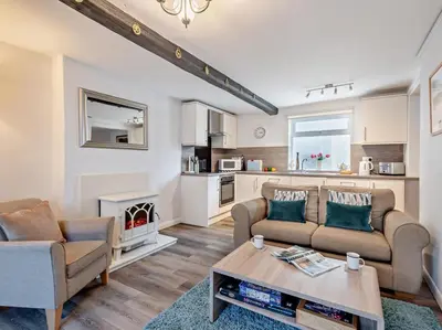 a living room with two couches and a table at 2 Bed in Keswick oc-sz140 in Keswick