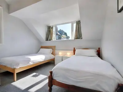 two beds in a small room with a window at 6 Bed in Keswick oc-sz389 in Keswick