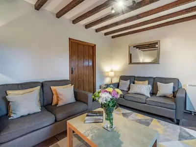 a living room with couches and a vase of flowers on a table at 2 Bed in Wasdale oc-tcsz436 in Santon Bridge