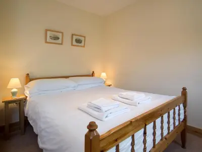 a bedroom with a large white bed with towels on it at 3 Bed in Egremont oc-sz058 in Hale