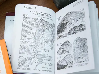 an open book with a drawing of a mountain at 3 Bed in Threlkeld SZ421 in Threlkeld