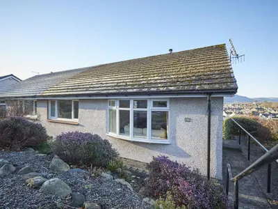 a white house with a window on the side of it at 2 Bed in Keswick oc-sz008 in Keswick