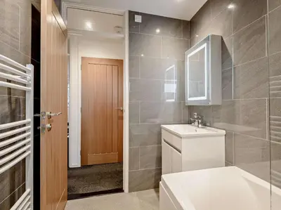 a bathroom with a toilet and a sink and a mirror at 2 Bed in Keswick oc-sz116 in Keswick