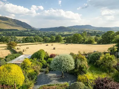 an aerial view of a garden with a field and mountains at 2 Bed in Threlkeld SZ082 in Threlkeld