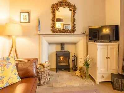 a living room with a fireplace and a mirror at 2 Bed in Threlkeld SZ082 in Threlkeld