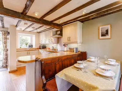 a kitchen with a table with plates on it at 2 Bed in Keswick oc-sz341 in Portinscale