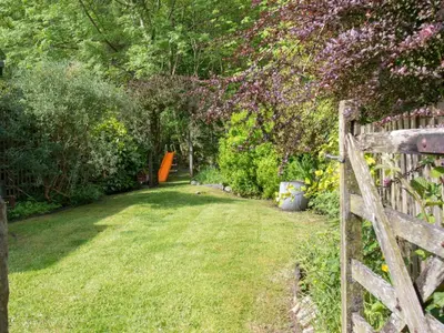a garden with a wooden fence and flowers at 2 Bed in Keswick oc-sz068 in Rosthwaite