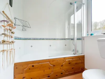 a bathroom with a bath tub and a toilet at 2 Bed in Keswick oc-sz068 in Rosthwaite