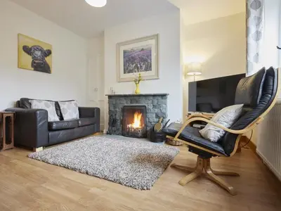 a living room with a couch and a fireplace at 2 Bed in Keswick oc-sz068 in Rosthwaite