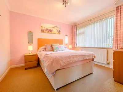 a bedroom with a bed with pink walls and a window at 1 Bed in Keswick SZ133 in Keswick