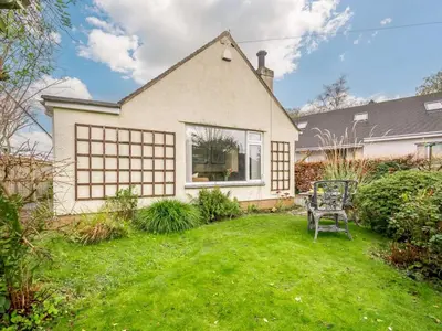 a house with a lawn and a chair in the yard at 1 Bed in Keswick SZ133 in Keswick