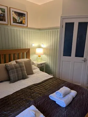 a bedroom with a bed with towels on it at Daffodil Cottage in Cockermouth