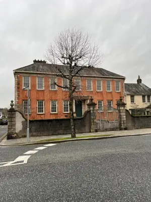 a large brick building with a tree in front of it at Daffodil Cottage in Cockermouth