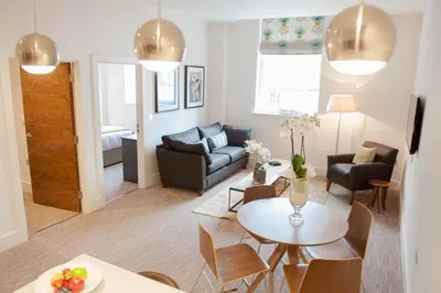a living room with a couch and a table at The Halston Carlisle in Carlisle