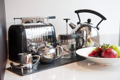 a kitchen counter with a toaster and a bowl of fruit at The Halston Carlisle in Carlisle