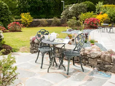 an outdoor table and chairs in a garden at 4 Bed in Keswick SZ267 in Keswick