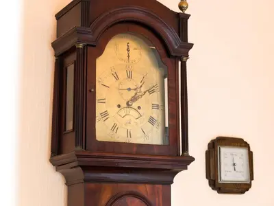 a grandfather clock sitting on a wall next to a clock at 3 Bed in Applethwaite SZ168 in Applethwaite