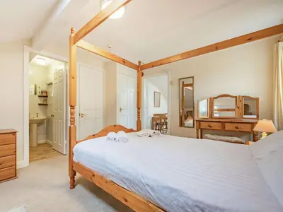 a bedroom with a large bed with a wooden frame at 1 Bed in Penrith oc-sz295 in Dockray