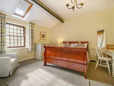 a bedroom with a bed and a table in a room at 3 Bed in Keswick oc-sz065 in Applethwaite