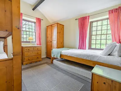 a bedroom with two beds and two windows at 3 Bed in Keswick oc-sz065 in Applethwaite