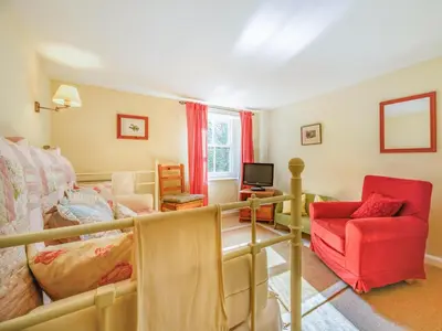 a living room with a couch and a red chair at 3 Bed in Keswick oc-sz065 in Applethwaite