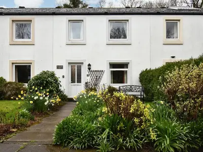 a white house with a garden in front of it at 3 Bed in Keswick SZ547 in Keswick