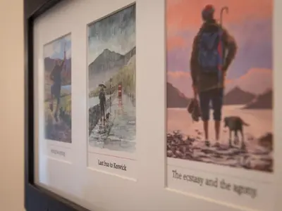 a framed picture of a painting of a man with a dog at 2 Bed in Keswick oc-sz490 in Keswick