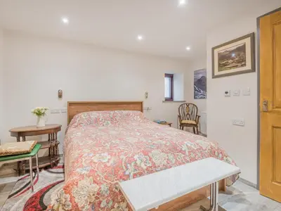 a bedroom with a bed and a table and chairs at 3 Bed in Borrowdale SZ465 in Rosthwaite