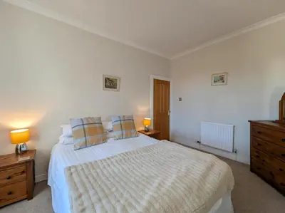 a bedroom with a bed with two lamps and a dresser at 3 Bed in Keswick SZ187 in Keswick