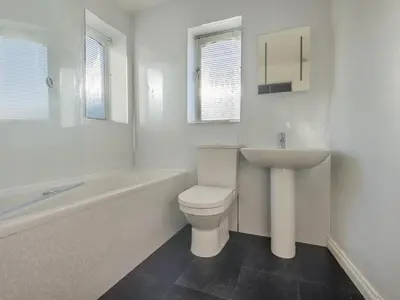 a white bathroom with a toilet and a sink at 3 Bed in Keswick SZ187 in Keswick