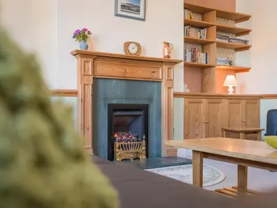 a living room with a fireplace and a table at 3 Bed in Keswick SZ187 in Keswick