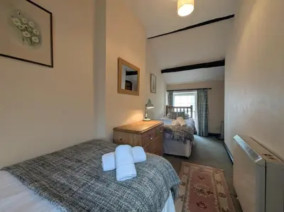 a bedroom with a bed with two towels on it at 2 Bed in Cockermouth oc-sz136 in Lorton