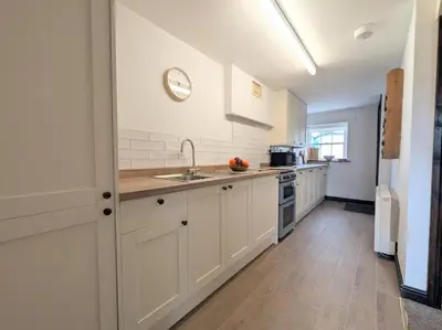 a kitchen with white cabinets and a sink at 2 Bed in Cockermouth oc-sz136 in Lorton